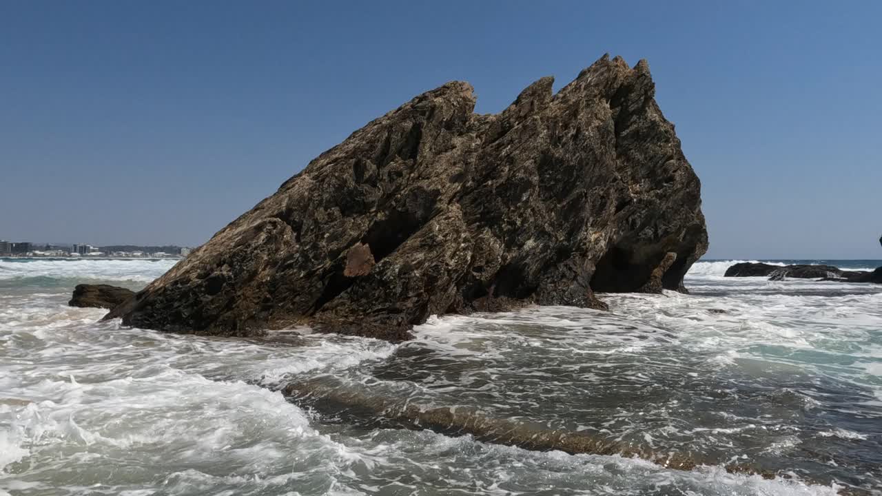 formación rocosa con olas que se estrellan en el callejón currumbin en gold coast, queensland