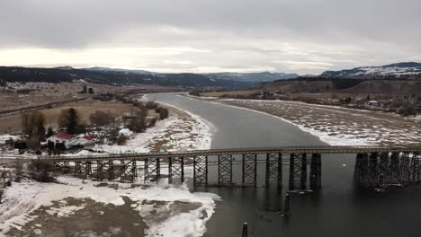 the wooden structure of the pritchard bridge in a majestic winter landscape