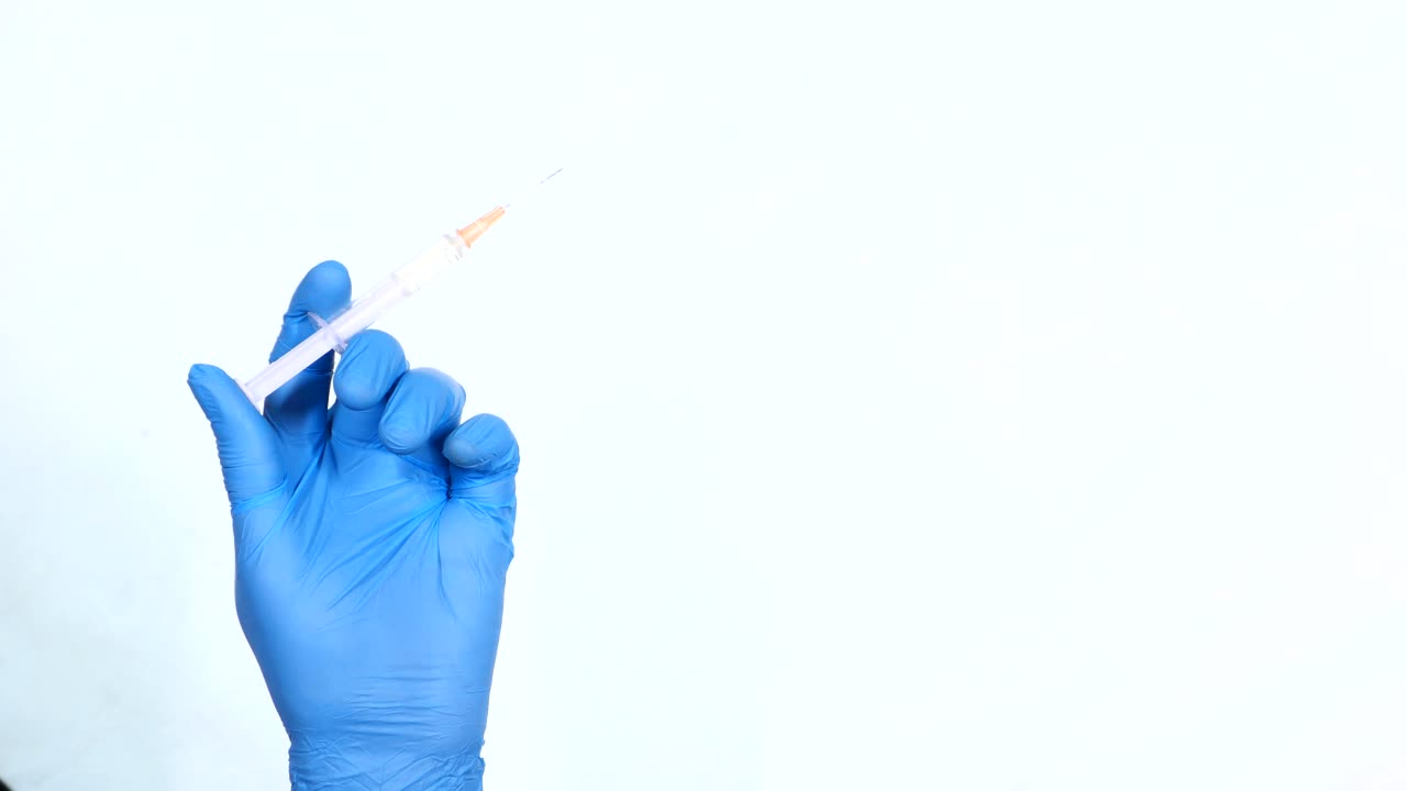 Hand holding syringe