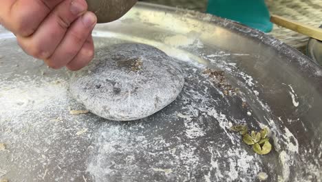 Grinding-spice-cardamom-seed-with-stone-grinder-in-a-traditional-way-method-for-the-best-aroma-and-taste-use-in-culinary-food-and-baking-bread-in-a-home-bakery-healthy-herbs-ingredients-fresh-cooking