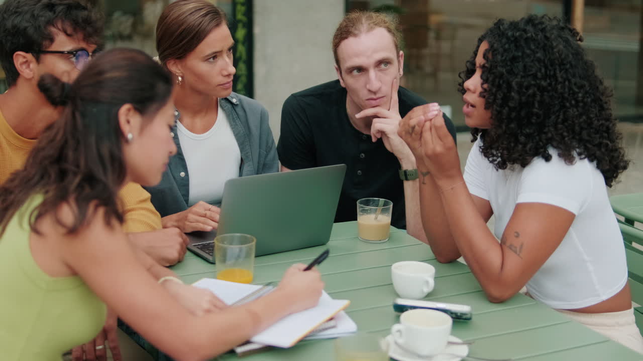 Close up of a diverse group of students using computer. Focus on the African