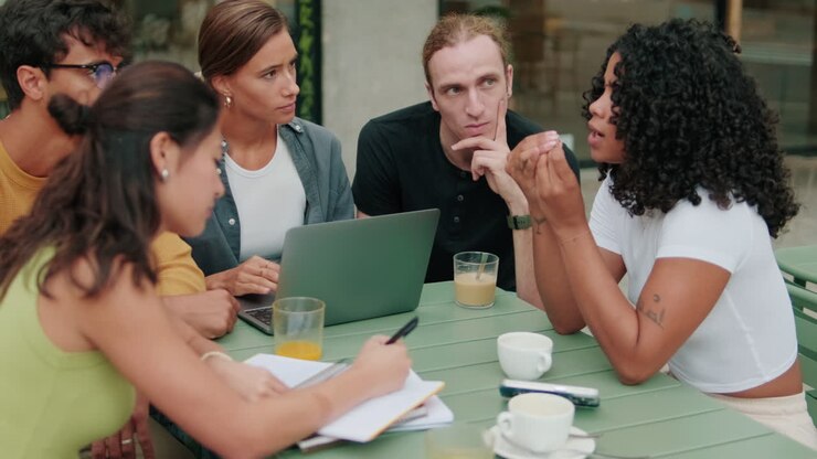 Close up of a diverse group of students using computer. Focus on the African