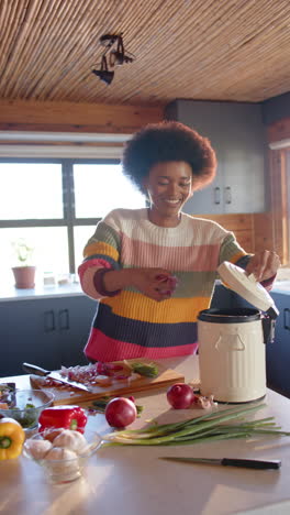 slow-motion video shows joyful african american woman composting in kitchen