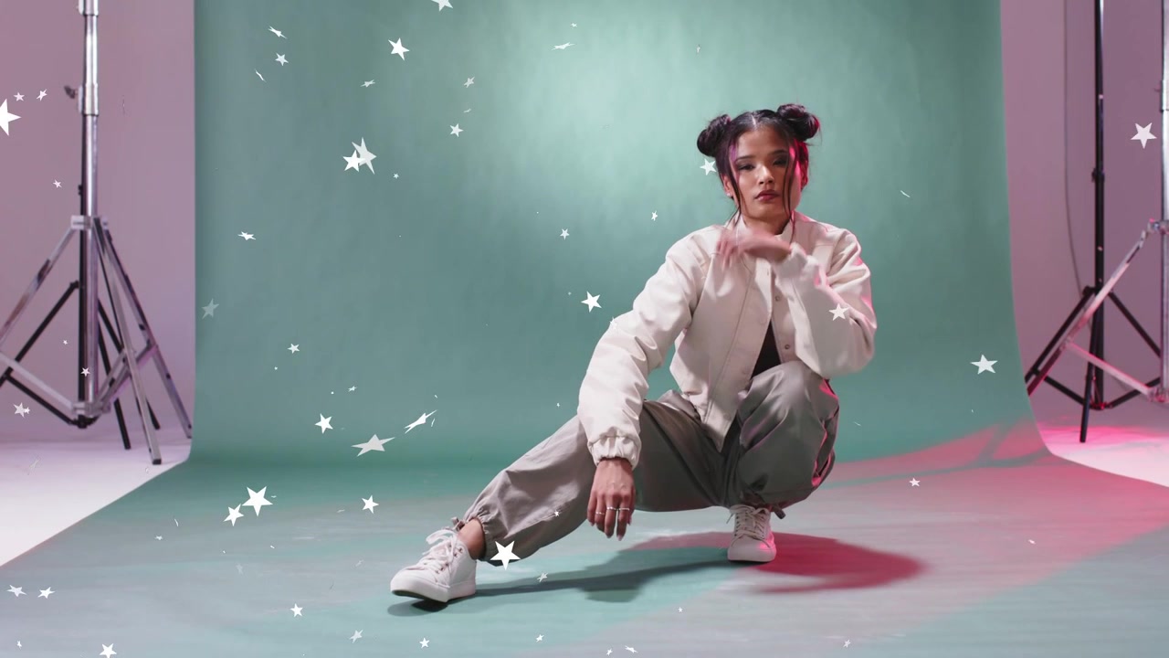 Woman shifting side lunge on green screen for portrait shoot on cue, stars drifting over her