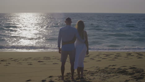 young couple in love looking at beautiful ocean