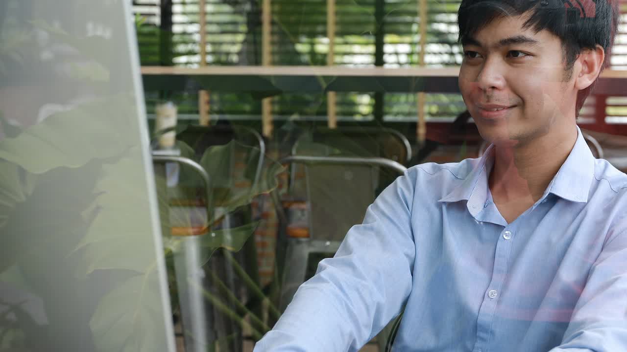 smiling asian businessman working in office