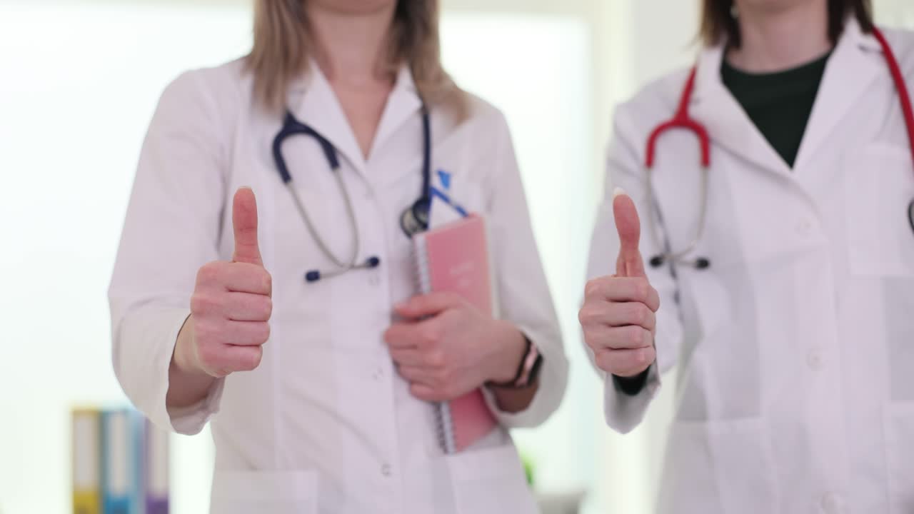 Two doctors giving thumbs up