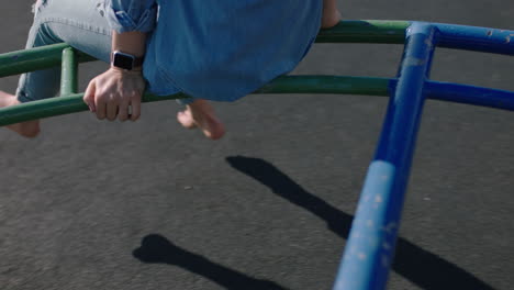 close up feet woman on merry go round spinning legs dangling barefoot enjoying fun on summer vacation teenage girl barefoot in school yard