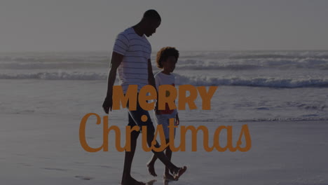 animation of merry christmas text over african american man and his son at beach