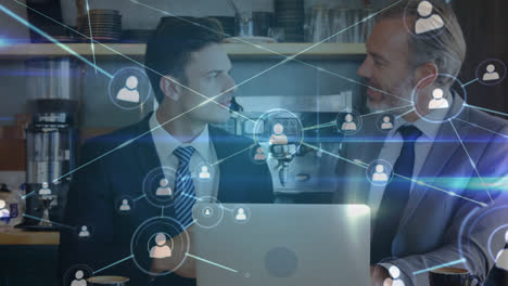 animación de redes de conexiones sobre dos empresarios caucásicos usando una computadora portátil