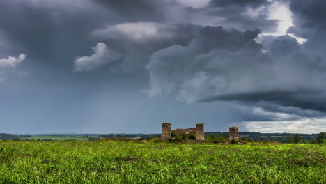 historic brick structure on green meadows over clouded sky