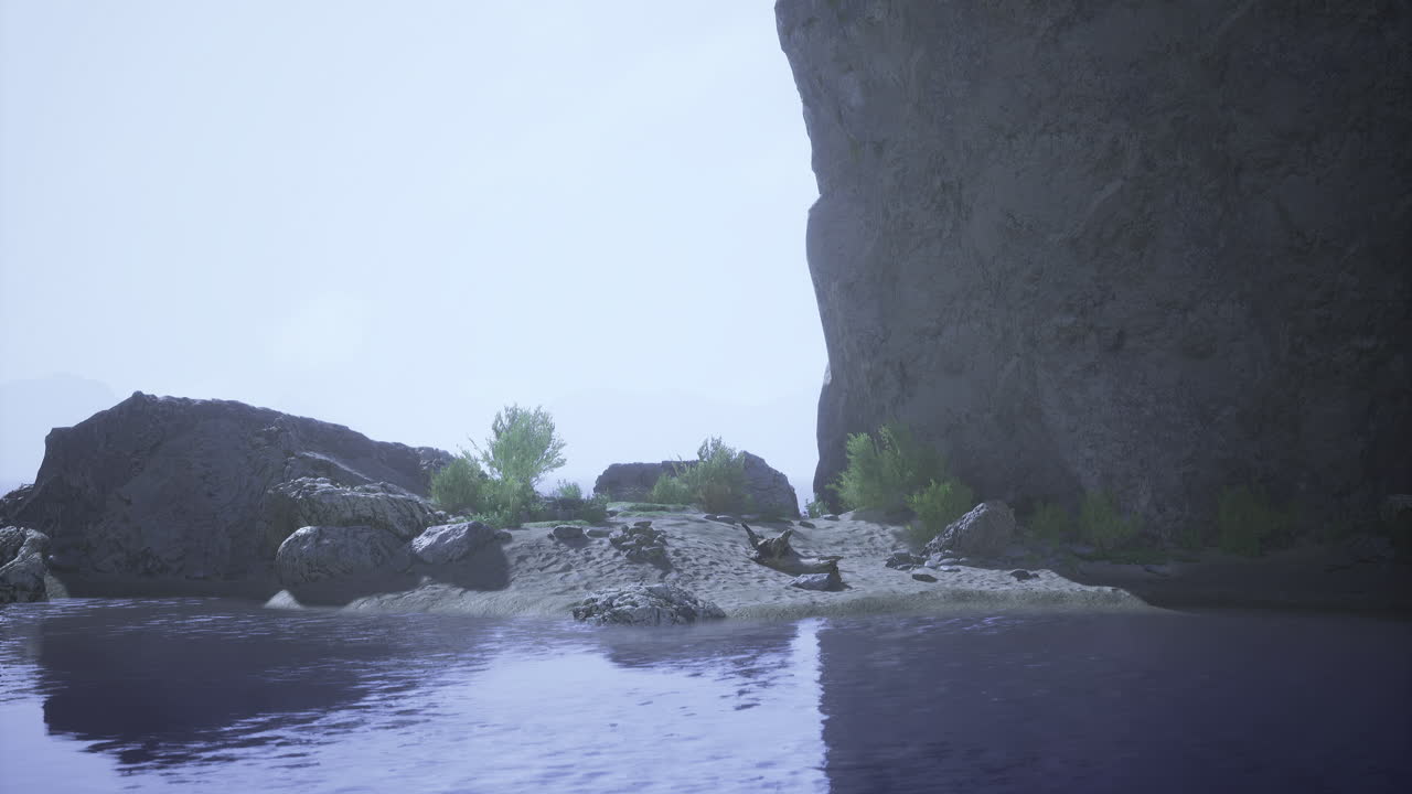 Rocky coastline by calm water with greenery under hazy sky in tranquil setting