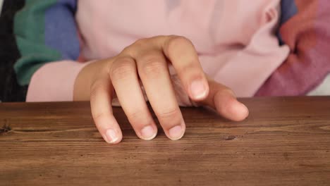 woman's hand resting on a table