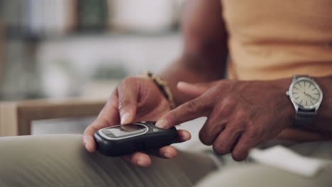 a man checking his blood sugar levels at home