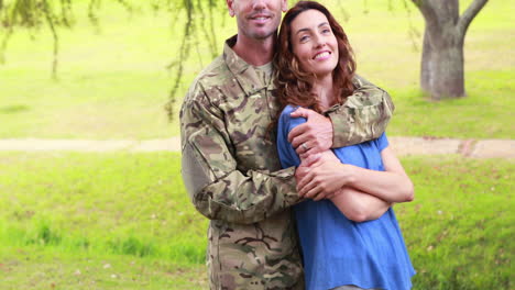 un soldado feliz abrazando a su esposa.