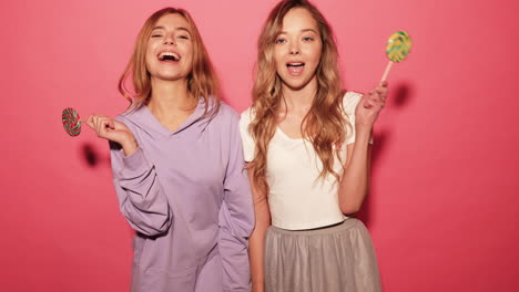 two women with lollipops in studio