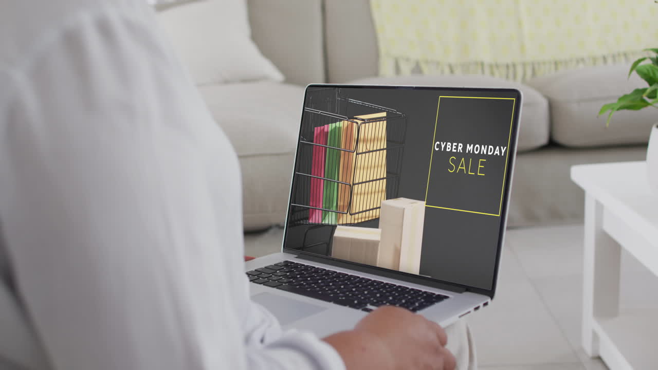 mujer biracial usando una computadora portátil en casa para comprar en línea en cámara lenta