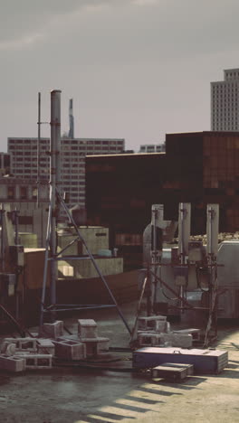city rooftop view showcasing buildings and ventilation systems in evening light
