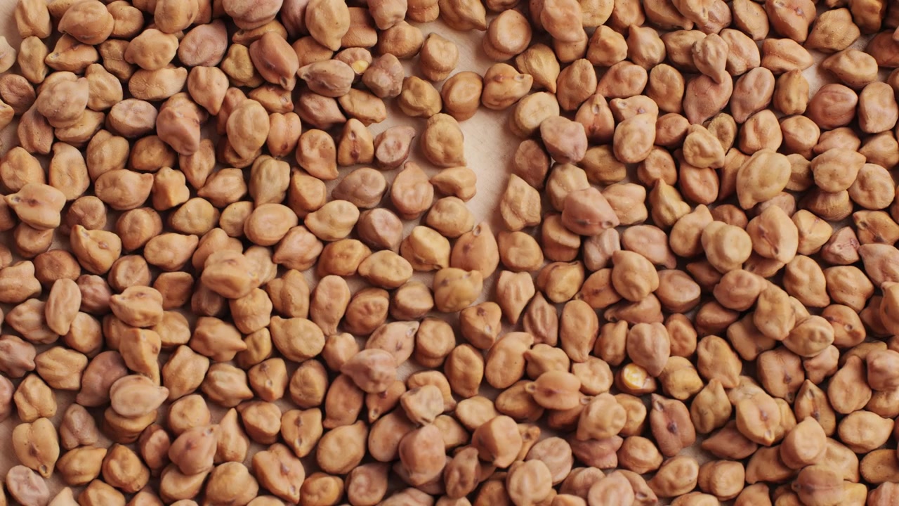 Overhead View of Dry Chickpeas Falling and Spreading