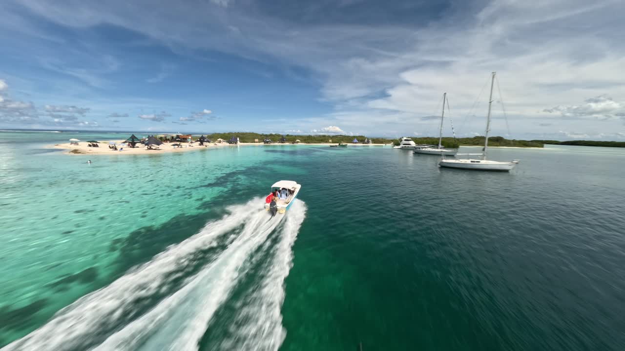Video made with a fpv drone of a small yacht approaching the coast in FRANCISKI, LOS ROQUES