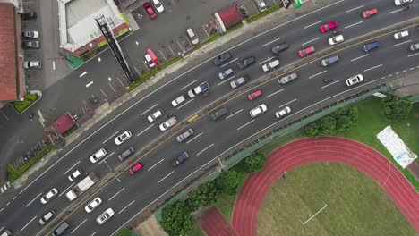 activity of urban traffic along a busy street adjacent to a well-maintained track and field complex