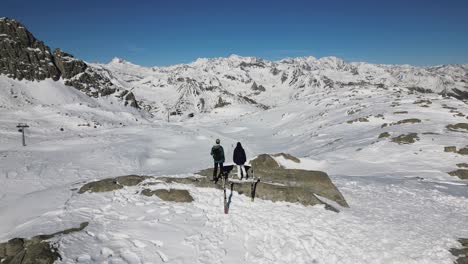 hikers traverse snowy landscape in the italian alps with stunning mountain views under clear skies