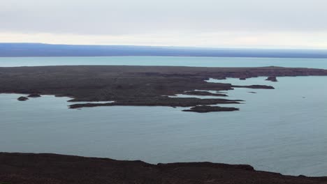panoramic view of a turquoise lake and desert landscape in patagonia, argentina