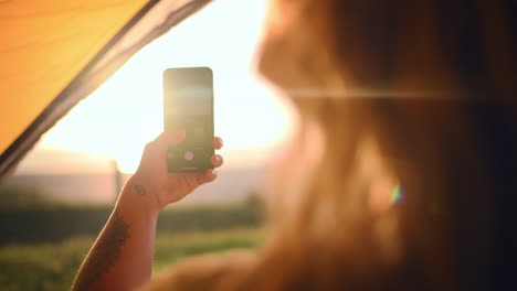 an unrecognizable woman taking pictures