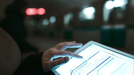 woman looking at underground map using touch pad