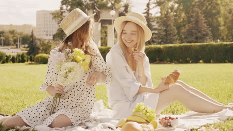 two friends enjoying a picnic in the park