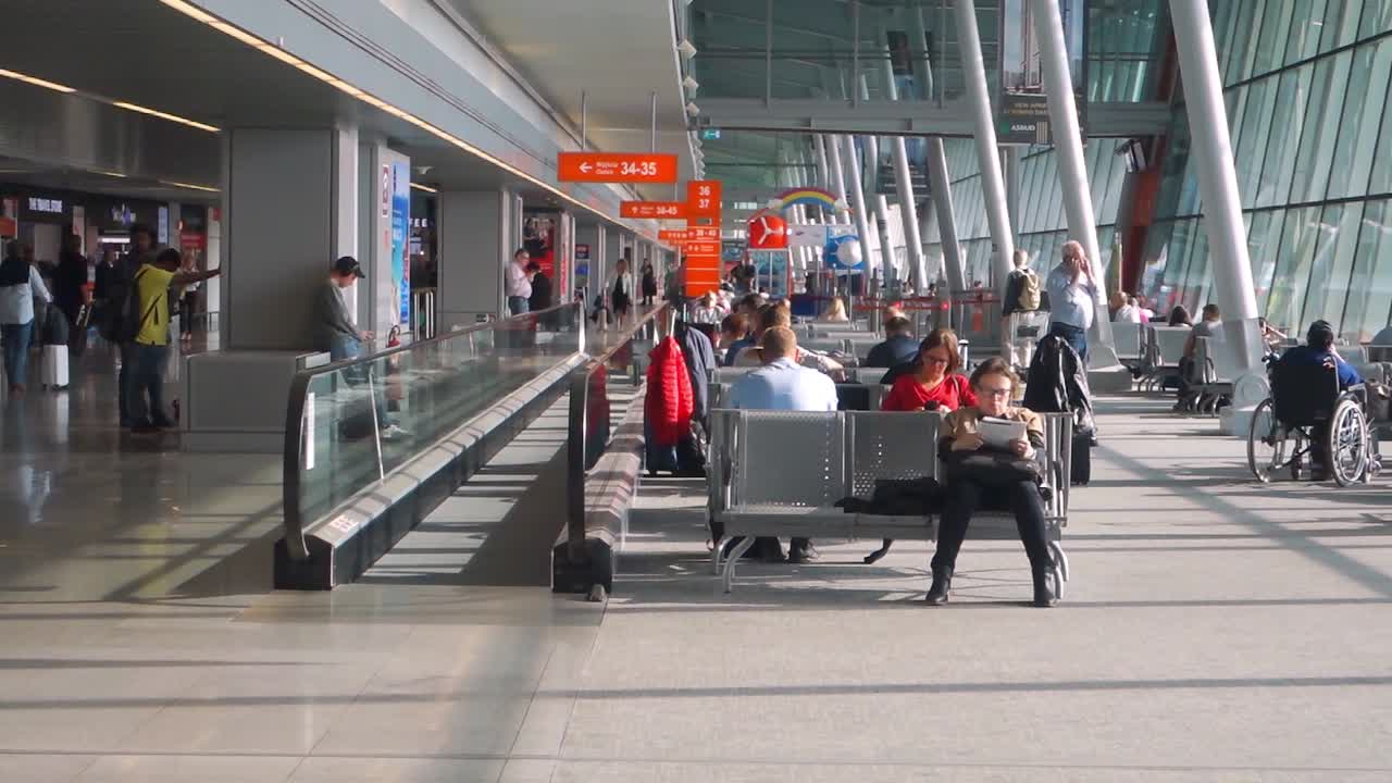 Passengers in transit at Warsaw Chopin airport, Poland. Warsaw Chopin Airport is, with 17.7 million passengers in 2018, the busiest airport in the newer EU.