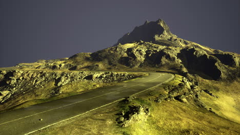 scenic winding road leading to a mountain summit under evening sky