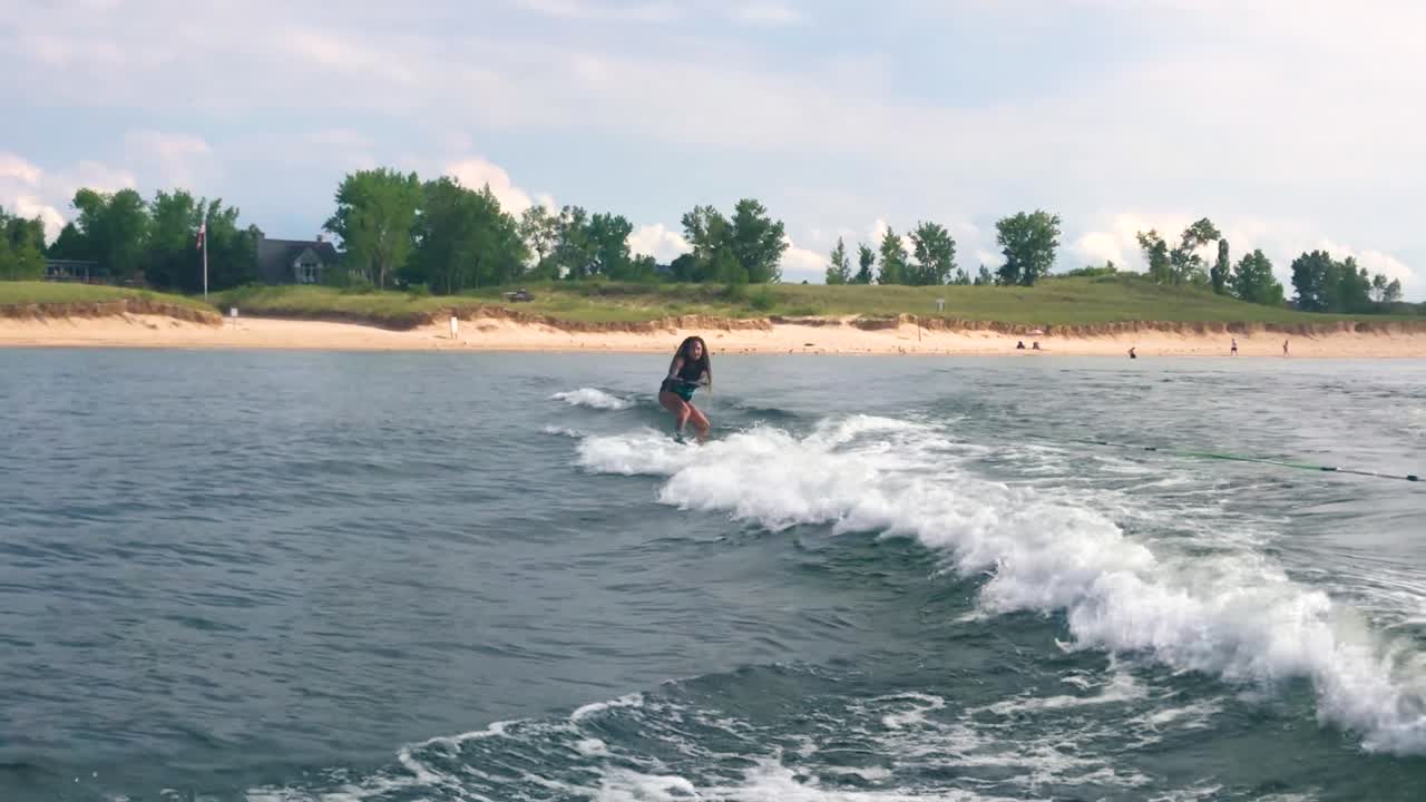 Girl wakeboarding near the beach