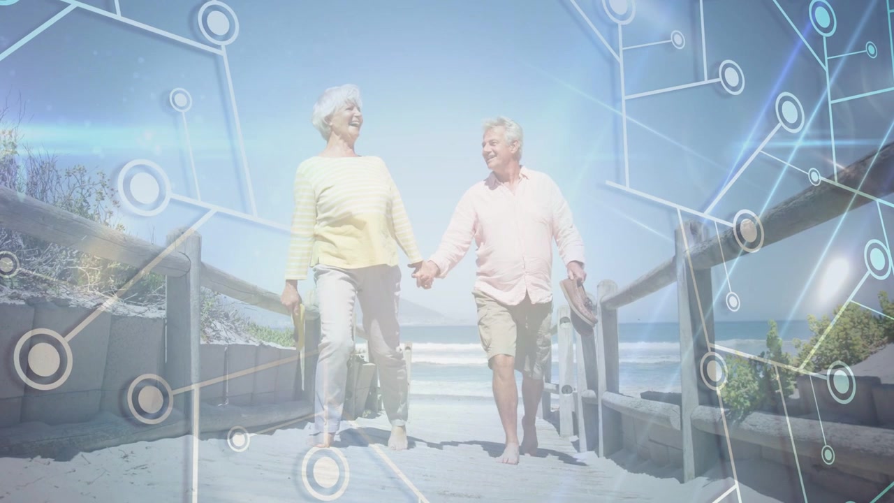 Senior couple walking down ramp toward shore, tech network overlay growing and linking around them