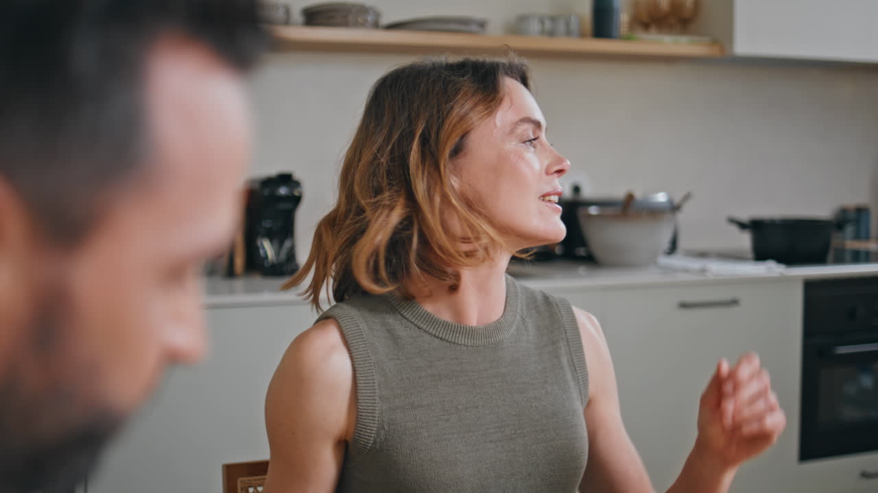 Laughing woman speaking family at kitchen closeup. Positive mother having fun