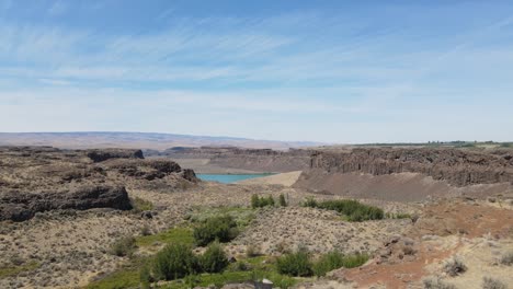 taking off the drone at water level and showing dusty lake from above