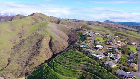 2020---vista-aérea-over-the-pacific-coastal-green-hills-and-mountains-behind-Ventura-California-including-suburban-homes-and-neighborhoods-4