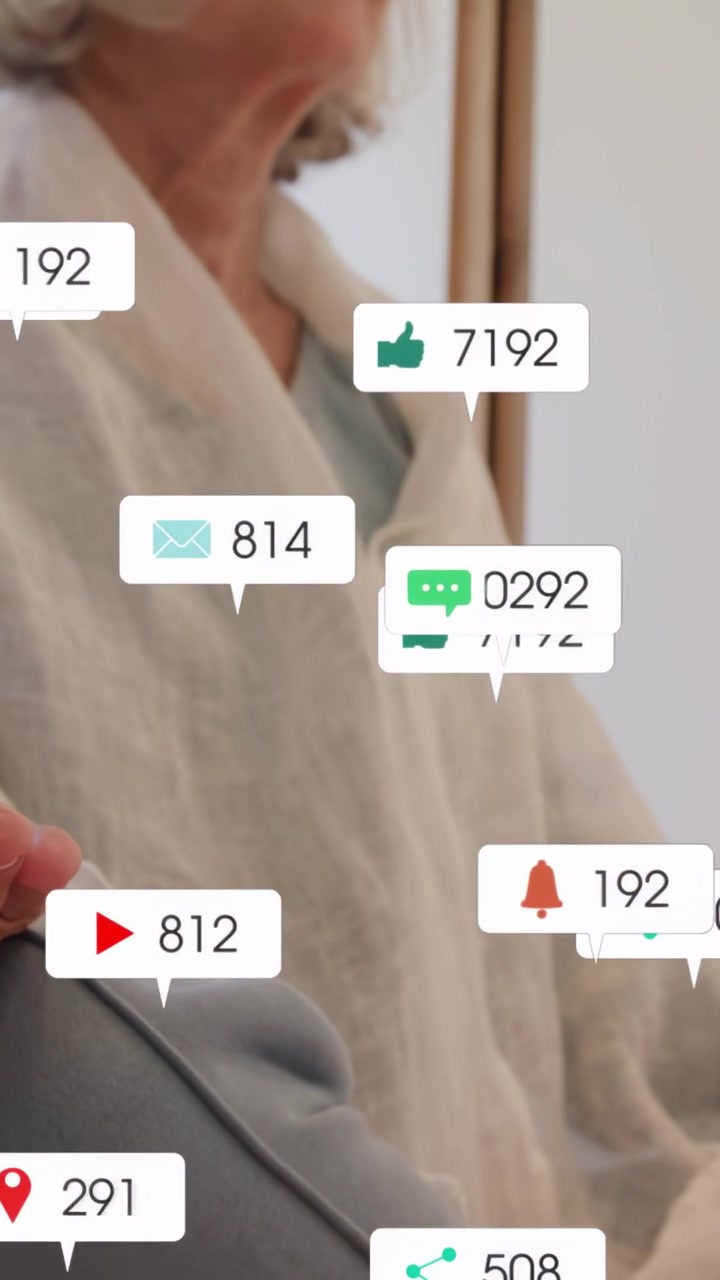 Vertical video: Senior woman sitting couch social alerts causing icons on torso then clearing