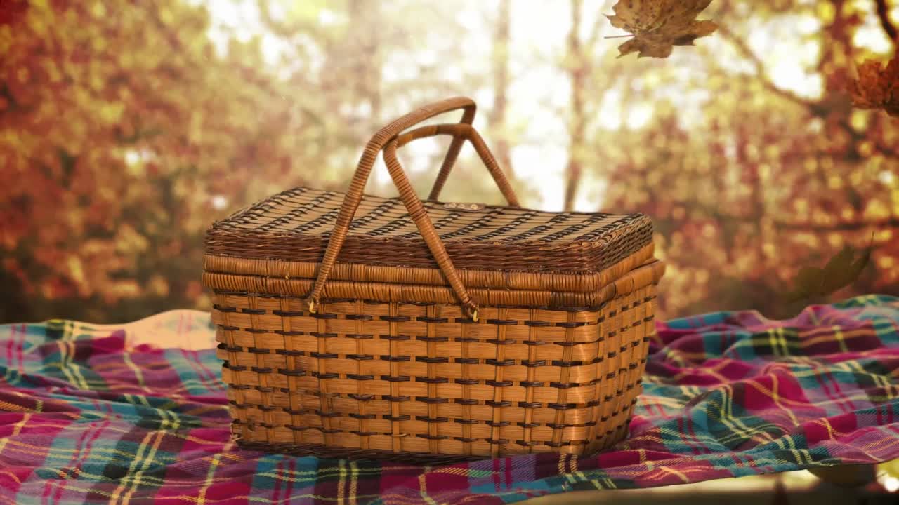 animación de las hojas de otoño que caen sobre la manta y la canasta de picnic