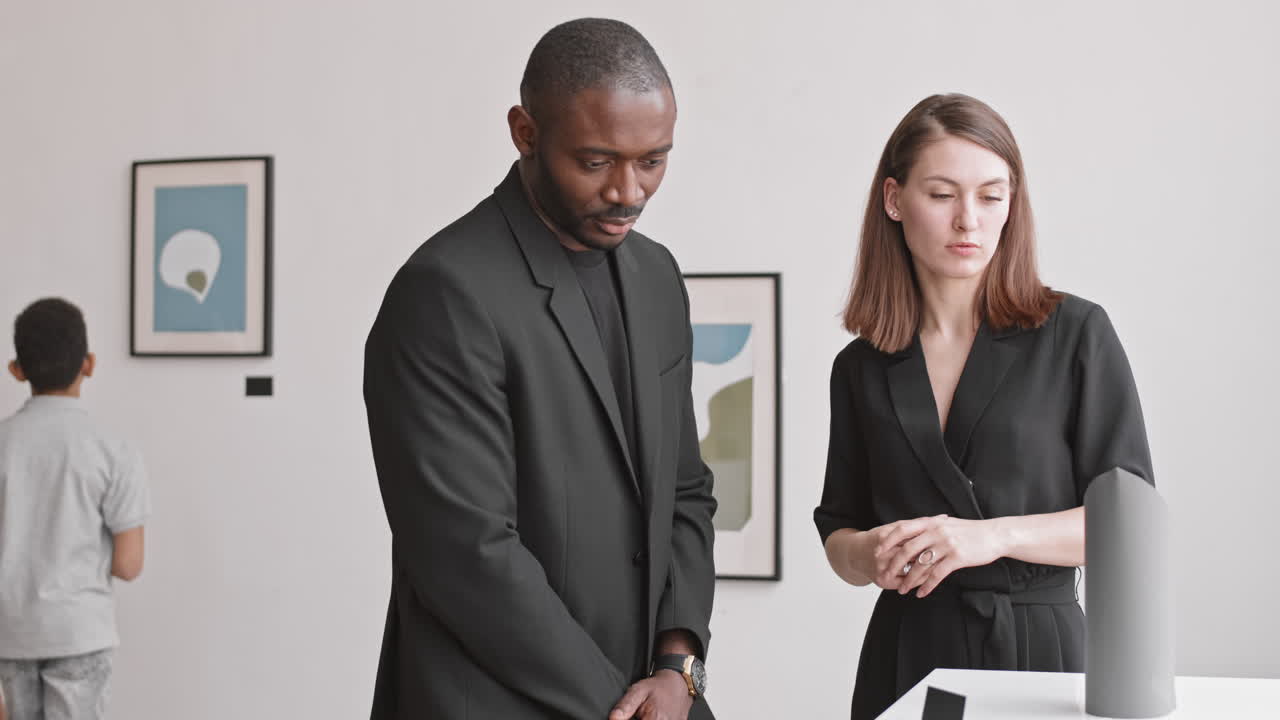 Couple Discussing Art Exhibit in Museum