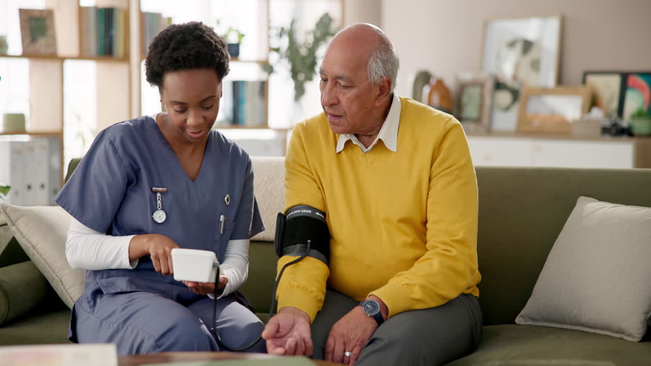 Nurse checking blood pressure of senior man at home