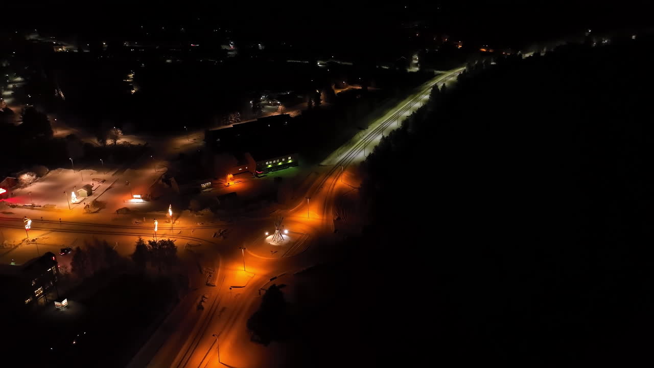 Aerial view circling the roundabout in the Salla town, winter night in Lapland