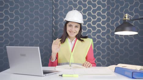 Woman-engineer-waving-at-camera.