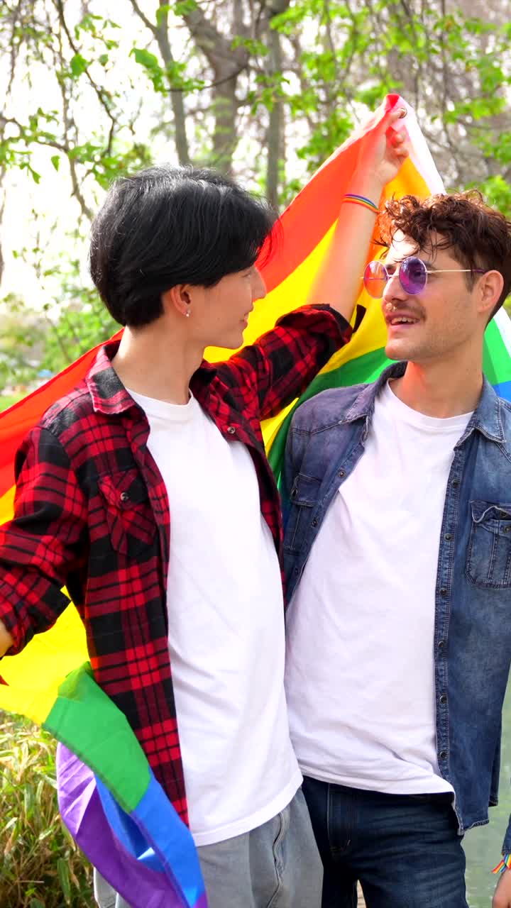 A couple celebrating LGBTQ pride with a rainbow flag