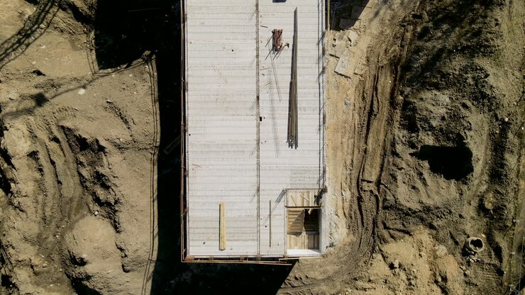 top down over construction site, concrete screed, aerial