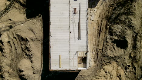 top down over construction site, concrete screed, aerial