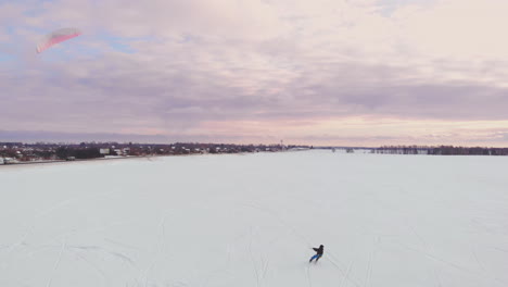 man-ski-on-snow-kite-holds-an-action-camera-and-takes-a-picture-of-Selfie.