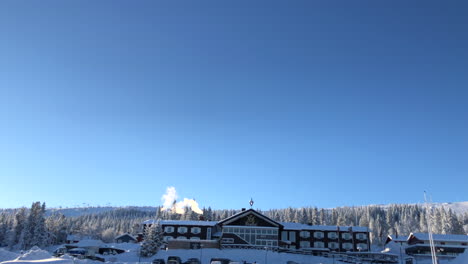 smoke coming out of chimney of a ski resort