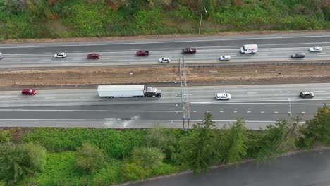 drone shot of a truck hauling goods on the freeway