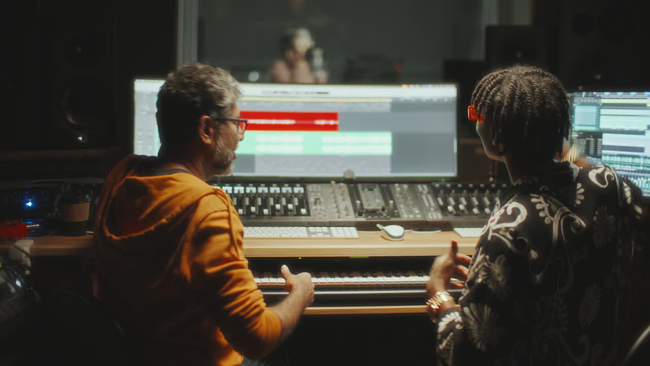 Sound Engineer Collaborating with Music Producer in Studio Control Room